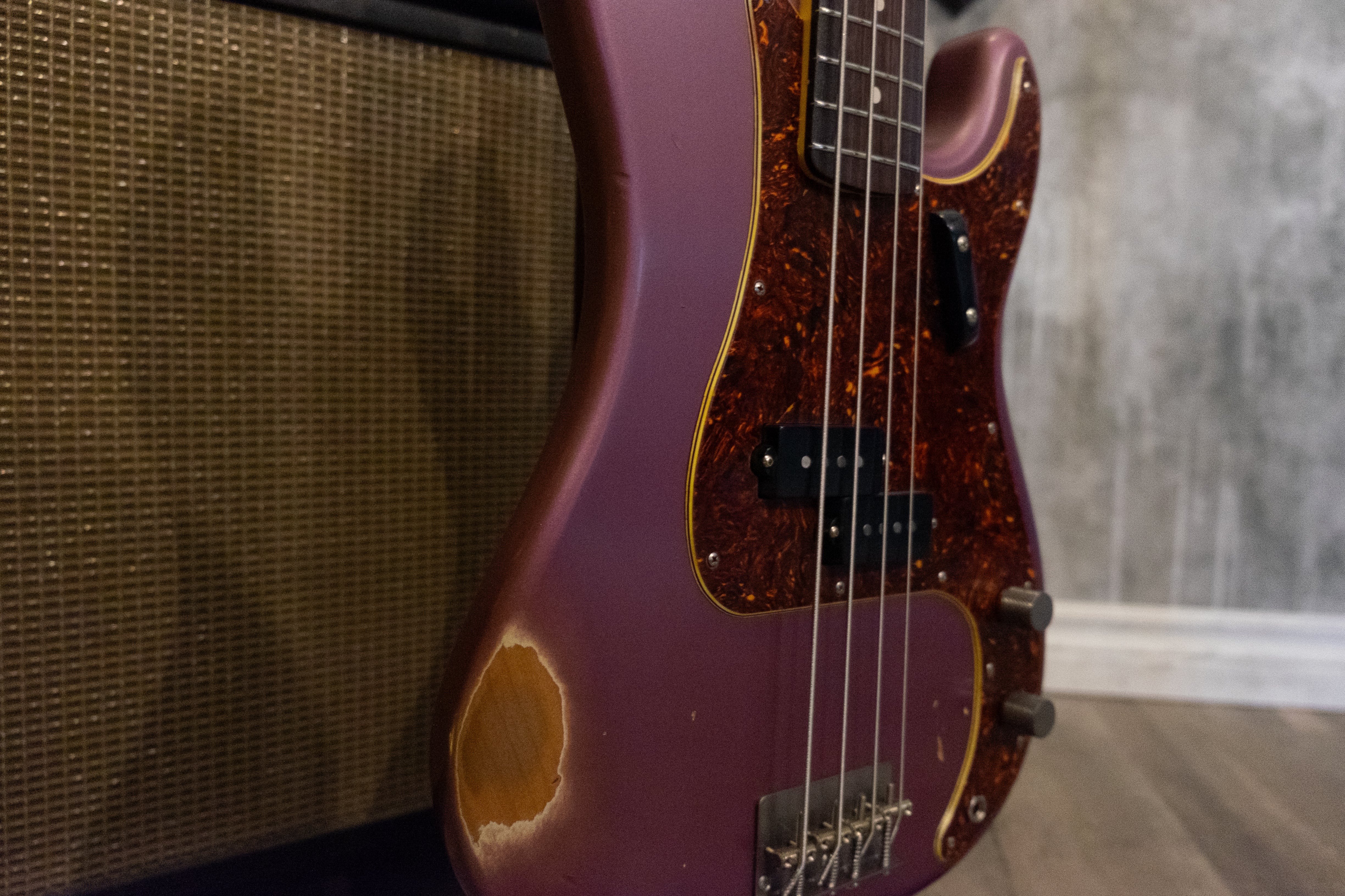 A Nash PB63 bass in Burgundy Mist with a vintage-style design, photographed with warm ambient lighting.