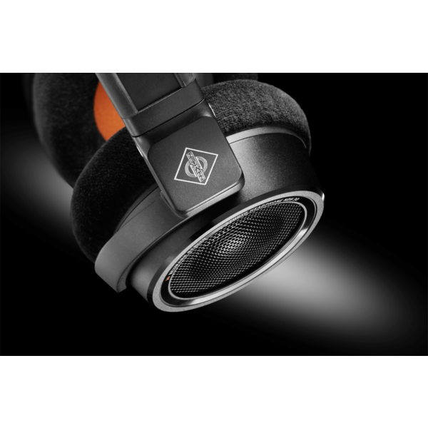 Close-up of folded Neumann NDH headphones, emphasizing the durable hinge mechanism, sleek metal finish, and compact design ideal for portable studio use.