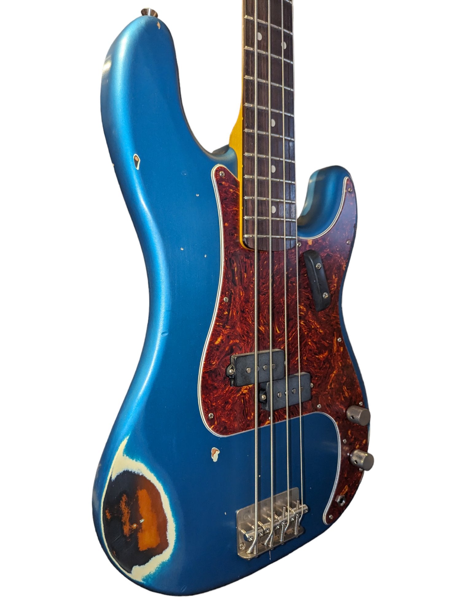 Side of a Nash electric bass guitar signs of wear and chipping are visible along the edges, adding to its vintage appeal.