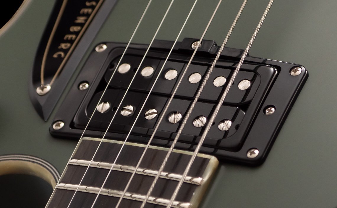 Duesenberg electric guitar, highlighting the matte olive green body with sleek black pickups and chrome accents. The strings and frets are sharply detailed, and the Duesenberg name is prominently displayed on the pickguard, showcasing precision and premium craftsmanship.